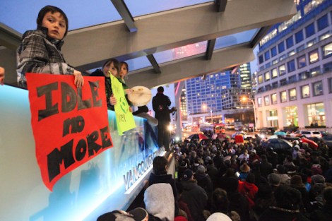 Idle No More participants in Vancouver, B.C. rally outside downtown's Canada Place, as local organizers prepare for another event at the U.S. border on January 5.