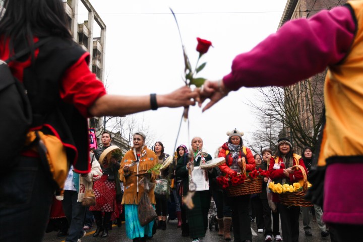 Carrying red roses for the dead and yellow for the missing, thousands marched through Vancouver's Downtown Eastside to end violence against aboriginal women in Canada. Photo by David P. Ball