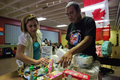 "We want to see a policy of zero barriers for migrants," says nurse Byron Cruz (right), with support worker Araceli Orozco (left) while preparing baby supplies for migrant women. Photo by David P. Ball