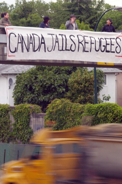 No One Is Illegal Vancouver dropped a "Canada Jails Refugees" banner during morning rush hour in opposition to the government's anti-refugee Bill C-4. Photo by David P Ball
